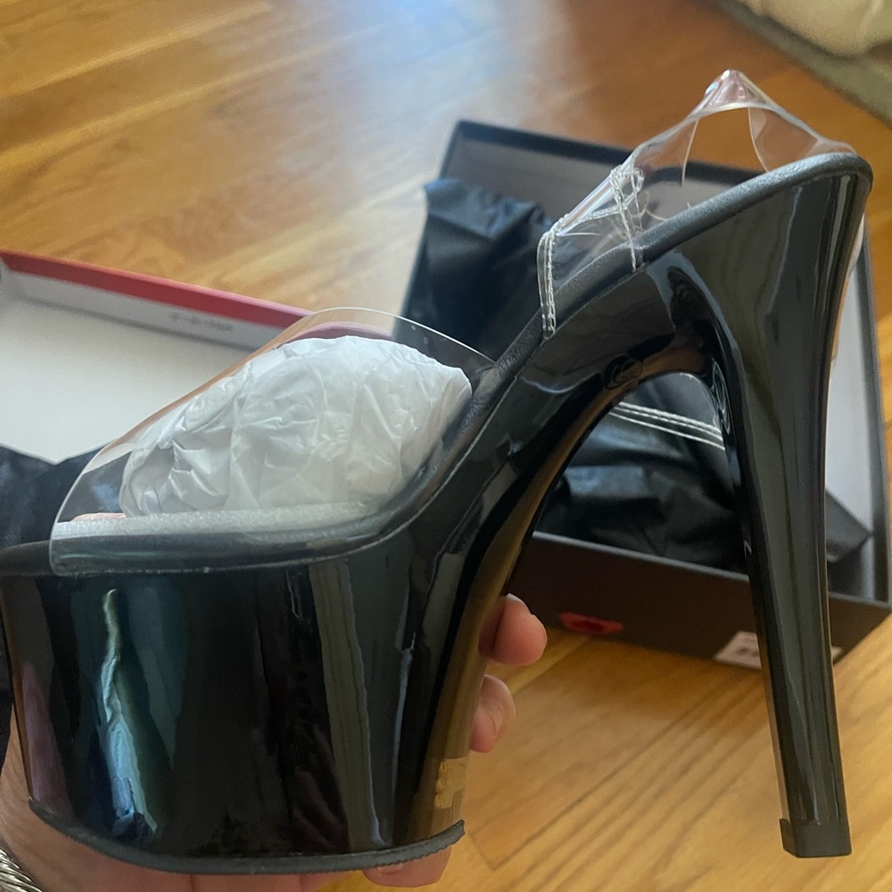 Pleaser platform shoes.  Black bottom clear straps